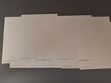 four sheets of white paper sitting on top of a table