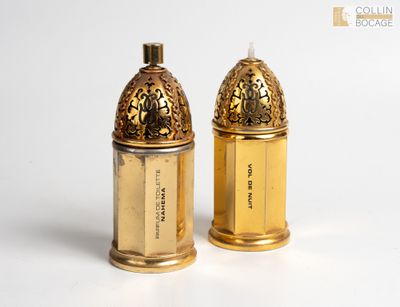 pair of gold plated salt and pepper shakers on a white surface