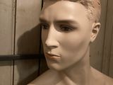 a mannequin of a man with a necklace on his neck