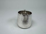 a silver cup that is sitting on a table