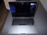 a laptop computer sitting on a table with a person in the background