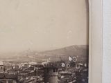 an old photo of a view of a city from the top of a building