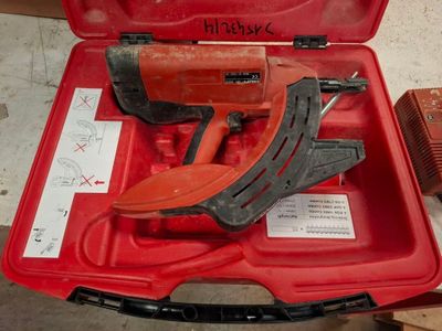 a red tool box with tools in it on the floor