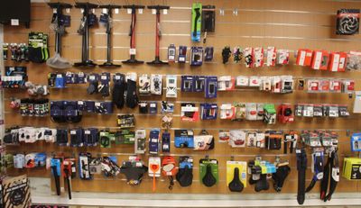 a wall of skis and snowboards on display in a store