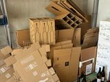 many boxes and bottles of wine sitting on the floor