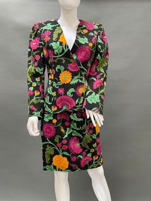 a mannequin wearing a black and pink floral print dress