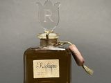 a bottle of perfume with a bird on top of it
