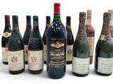 several bottles of wine are lined up in a row on a white surface