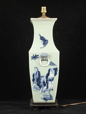 a blue and white vase with a bird on it