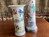 two vases that have flowers in them on a table
