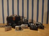 many different types of cameras sitting on a table