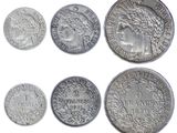 six different types of silver coins on a white background