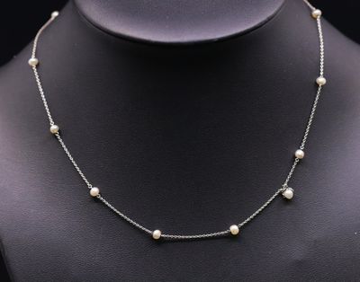 a necklace with pearls on a mannequin mannequin