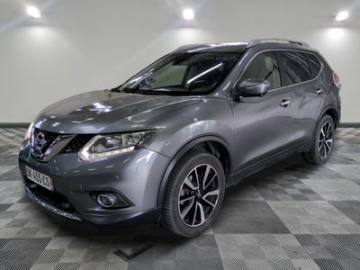 the nissan suv is parked in a large room with a checkered floor