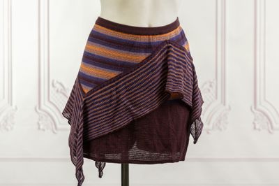an image of a mannequin wearing a purple and orange striped skirt