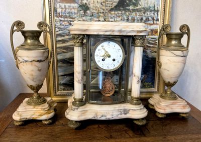 a picture of a clock and two vases on a table