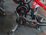 a red bicycle that is sitting on a black mat