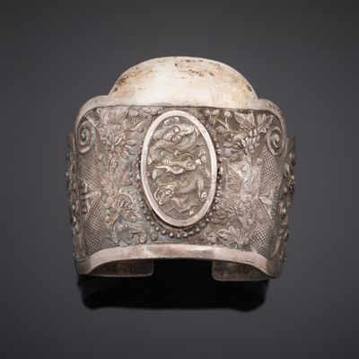 a silver bracelet with a picture of a man and woman on it