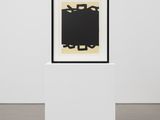 a black and white painting on a white pedestal in a white room
