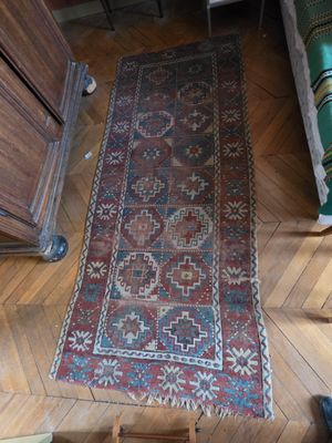 un tapis sur le sol dans une pièce avec une chaise