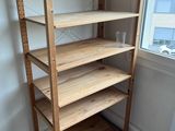a wooden shelf in the corner of a room