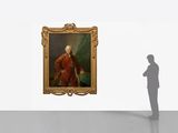 a shadow of a man standing in front of a painting