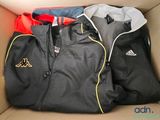 three jackets in a box that are sitting on top of each other