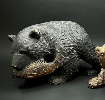 a statue of a bear and a bear cub sitting next to each other
