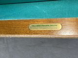 a close up of a pool table with a billiard ' s pipe mallise on it
