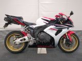 a picture of a red and white motorcycle parked on a checkered floor