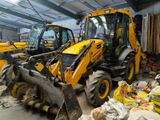 two yellow construction vehicles parked in a warehouse