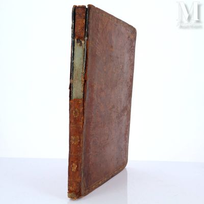 an old book that is sitting on a table