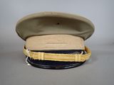 beige and blue hat with gold ribbon around the brim