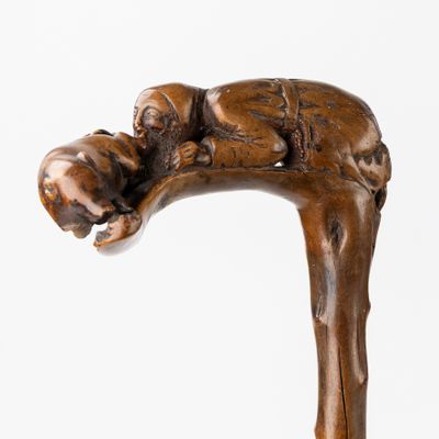 a statue of a man holding a dog on a stick