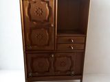 a wooden cabinet with a door and drawers on it