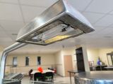 a metal object hanging from the ceiling in a room