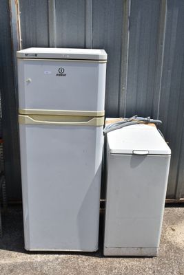 two refrigerators sitting next to each other in front of a building
