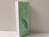 the box of a green tea is sitting on a white table