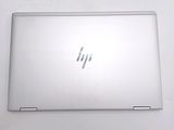 the back of a laptop computer sitting on top of a white table