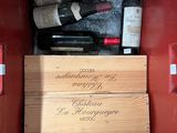 bottles of wine in a red box with labels on them