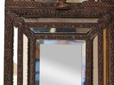 a mirror hanging on the wall with a bird on it