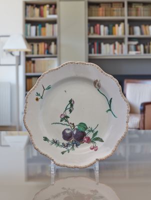 a plate that has a picture of plums on it