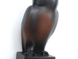 a statue of an owl sitting on top of a box