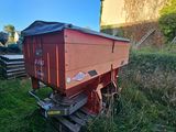 a red train car that is sitting in the grass