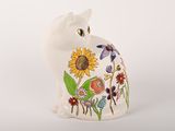 a white cat figurine with a sunflower design on it