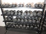 a rack of dumbs in a gym with dumbs on it