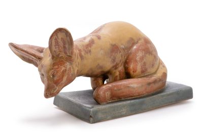 statue of a cat on a base on a white background