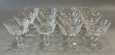 seven crystal wine glasses are lined up on a table