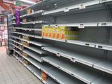 many empty shelves in a store with drinks on them