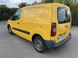 yellow van parked in a parking lot with trees in the background